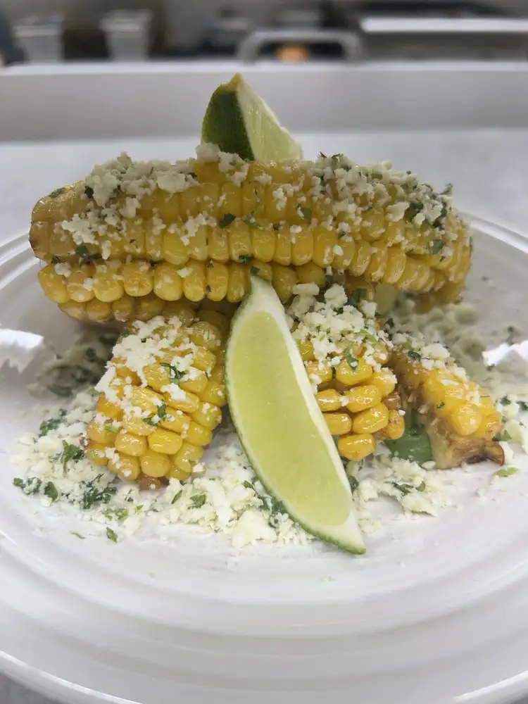 Elote corn ribs, lime, cotija cheese, chipotle créma